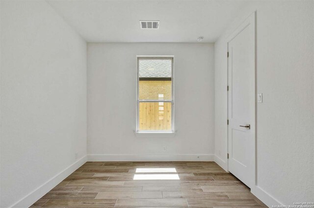 spare room featuring light hardwood / wood-style floors