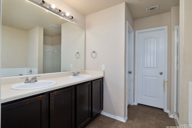 bathroom featuring a shower, vanity, and tile patterned floors