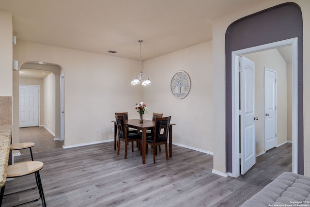 dining area featuring a notable chandelier and wood-type flooring