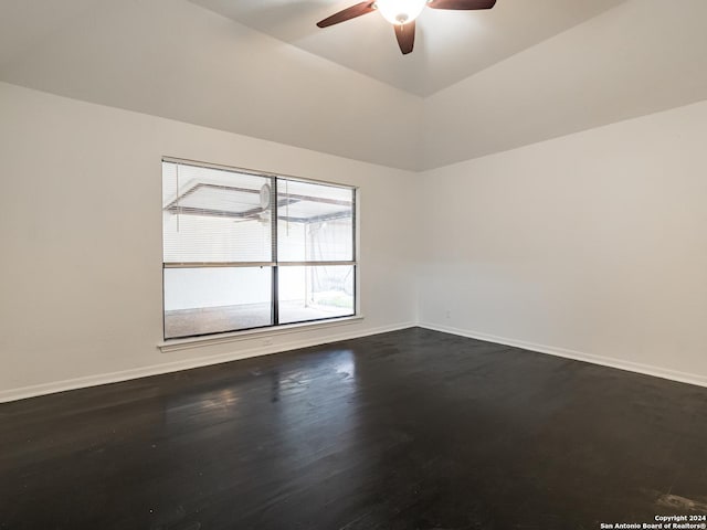 spare room with ceiling fan, wood-type flooring, and vaulted ceiling