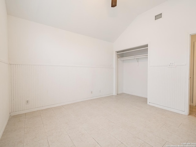 unfurnished bedroom with ceiling fan, lofted ceiling, and a closet