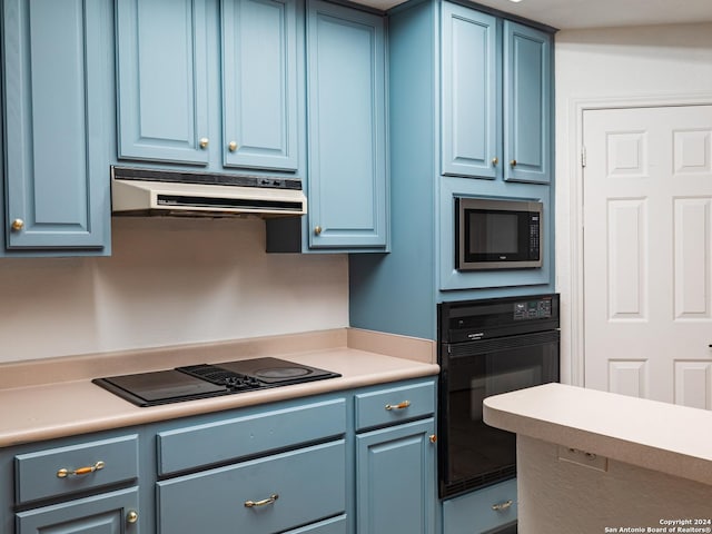 kitchen featuring black appliances and blue cabinets