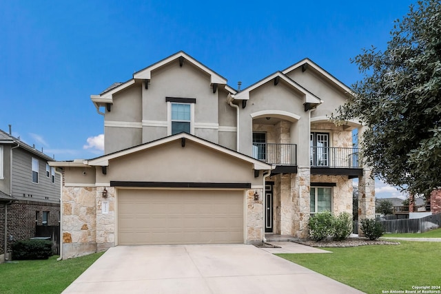 view of front of property with a garage, a balcony, and a front lawn