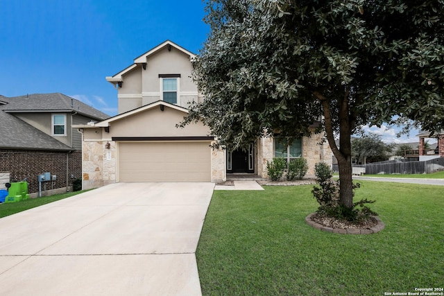 view of front of home with a front yard and a garage