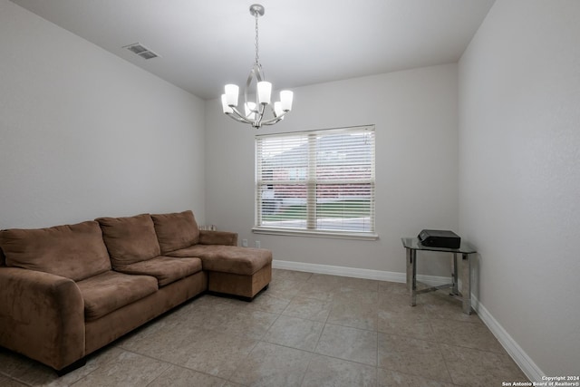 tiled living room featuring a chandelier