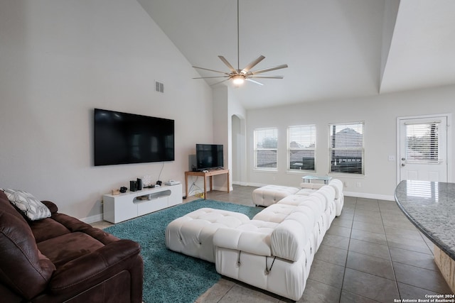 tiled living room featuring ceiling fan and high vaulted ceiling