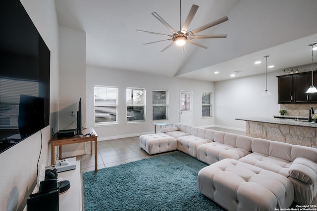 tiled living room with ceiling fan, lofted ceiling, and sink