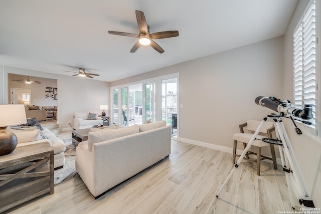 living room featuring light wood-type flooring and ceiling fan