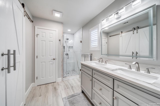 bathroom featuring hardwood / wood-style floors, vanity, and an enclosed shower