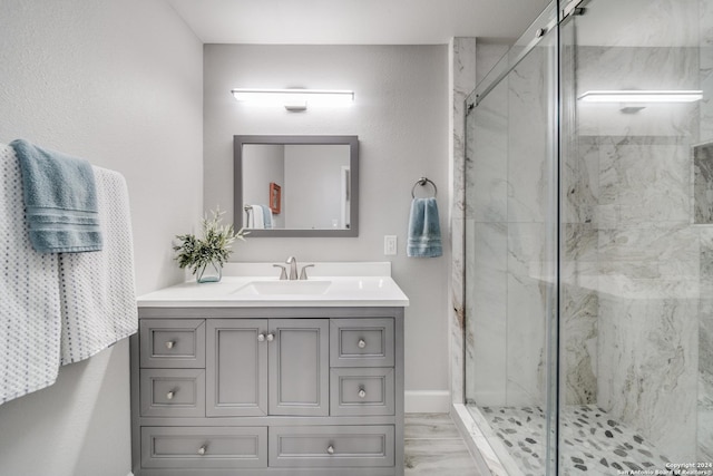 bathroom with hardwood / wood-style floors, vanity, and an enclosed shower