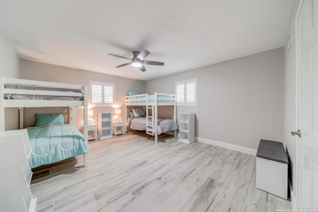 bedroom with multiple windows, ceiling fan, and light hardwood / wood-style flooring