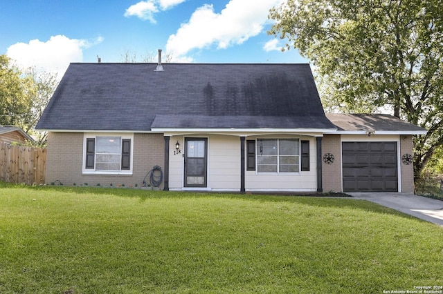 view of front of house with a garage and a front lawn