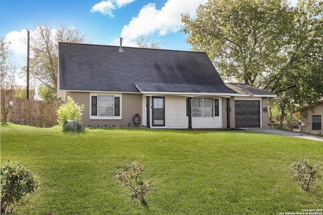 view of front of home featuring a front yard and a garage