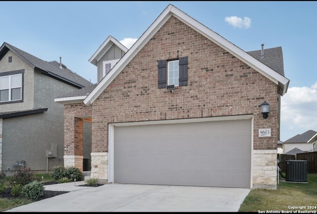 view of front of house with cooling unit and a garage