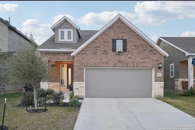 view of front of property featuring a garage and a front yard