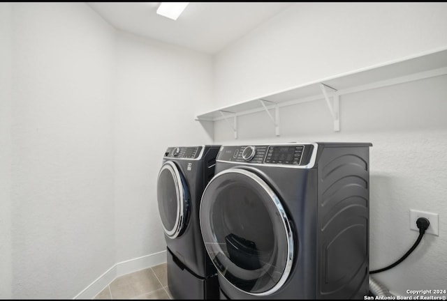 clothes washing area featuring separate washer and dryer and light tile patterned floors