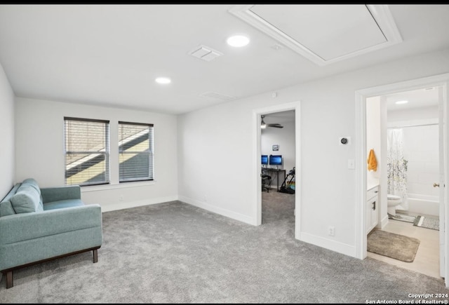 sitting room featuring light carpet and ceiling fan