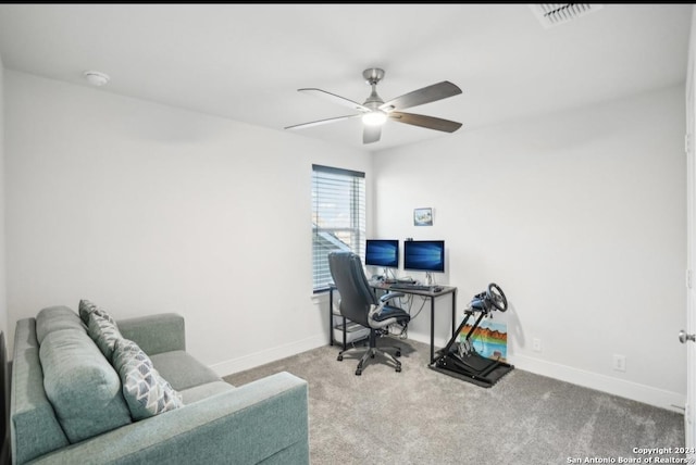 office space featuring light carpet and ceiling fan