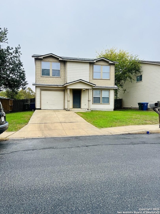 front facade featuring a garage and a front yard