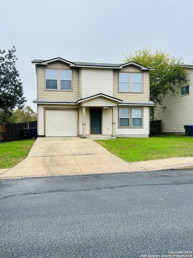 front of property with a garage and a front lawn