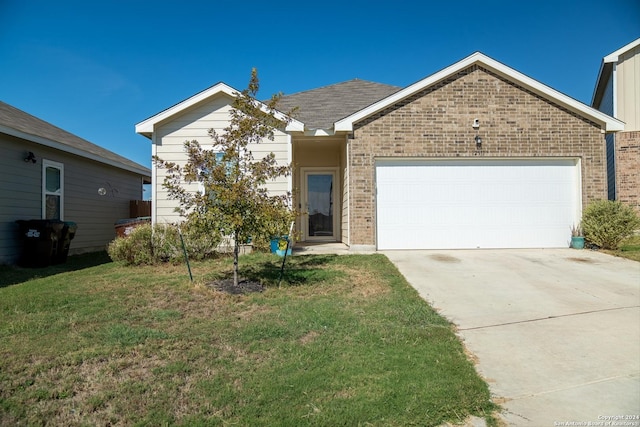 view of front of home with a garage and a front lawn