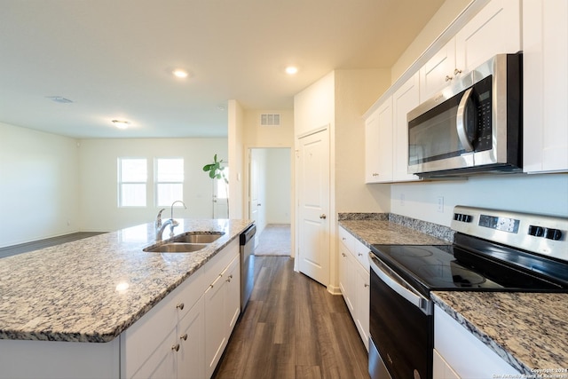 kitchen featuring white cabinetry, sink, stainless steel appliances, dark hardwood / wood-style flooring, and a kitchen island with sink