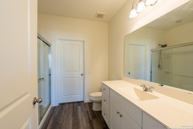 bathroom with vanity, wood-type flooring, and walk in shower