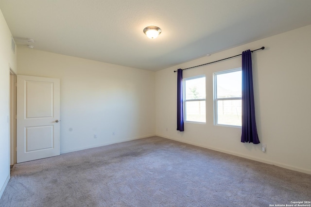 unfurnished room featuring light colored carpet