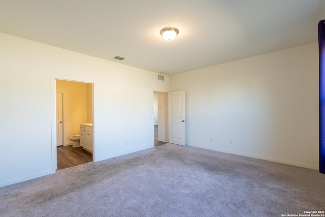 spare room with dark colored carpet