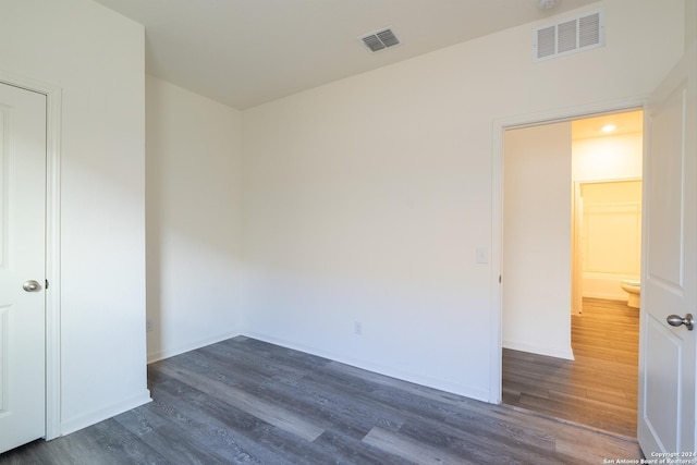 unfurnished bedroom with dark hardwood / wood-style flooring