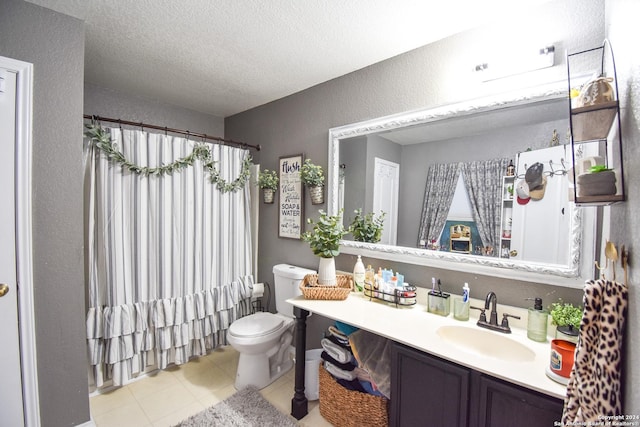 bathroom with vanity, tile patterned floors, toilet, a textured ceiling, and walk in shower