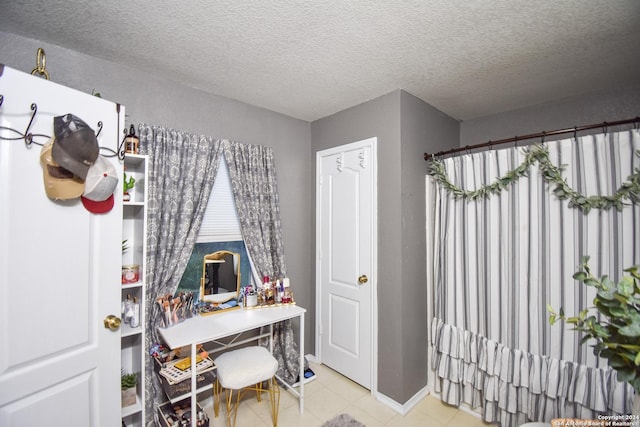 home office featuring a textured ceiling