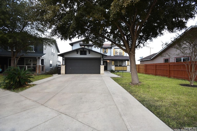 view of front facade with a garage, an outbuilding, and a front lawn