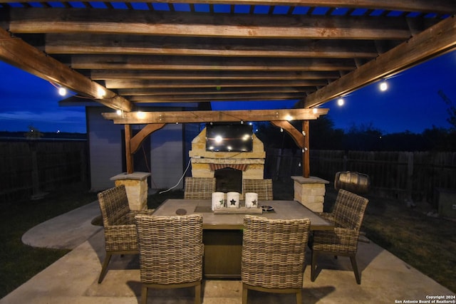 view of patio / terrace with an outdoor stone fireplace and a pergola