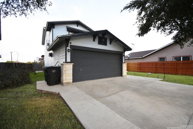 view of home's exterior featuring a yard and a garage