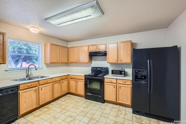 kitchen with black appliances, sink, and a textured ceiling