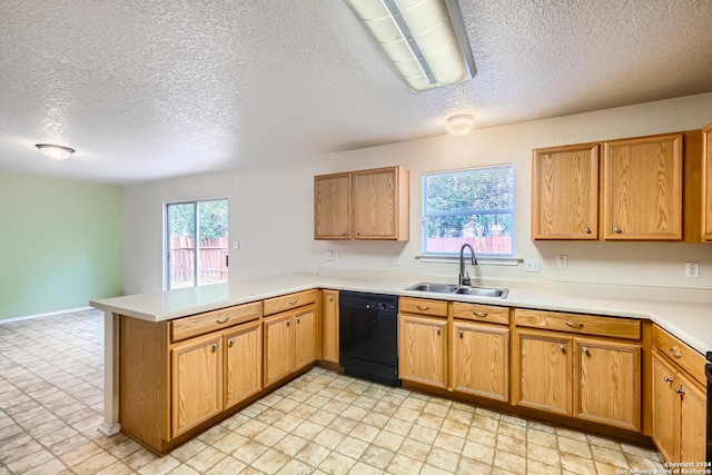 kitchen featuring dishwasher, a textured ceiling, kitchen peninsula, and sink