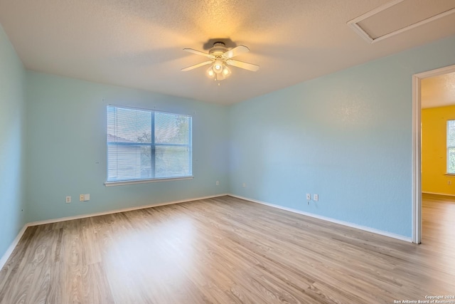 4735 Brook N, San Antonio, TX 78238 - empty room with wood finished floors, ceiling fan, baseboards, and a textured ceiling