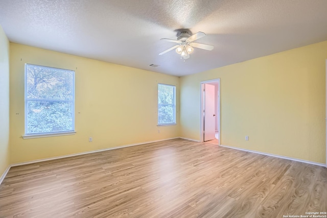 4735 Brook N, San Antonio, TX 78238 - unfurnished room with light wood finished floors, a ceiling fan, a textured ceiling, and baseboards