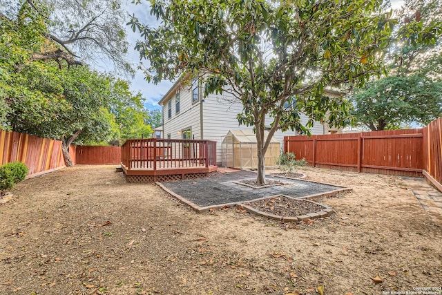 view of yard featuring an outbuilding and a deck