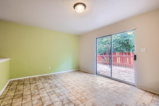 4735 Brook N, San Antonio, TX 78238 - empty room with stone finish flooring, a textured ceiling, and baseboards