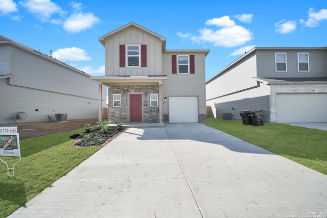 view of front of home with central AC unit, a garage, and a front lawn