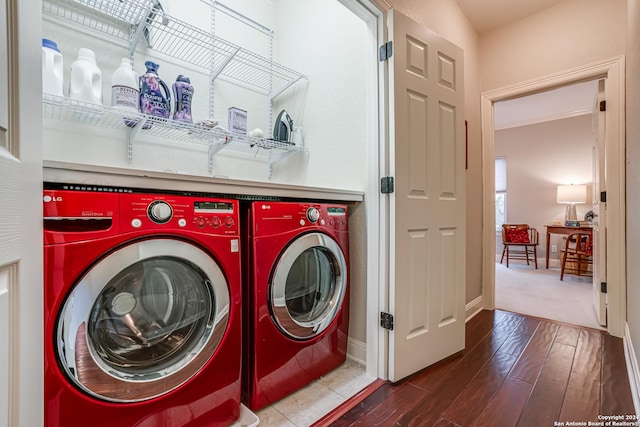 clothes washing area featuring wood-type flooring and separate washer and dryer