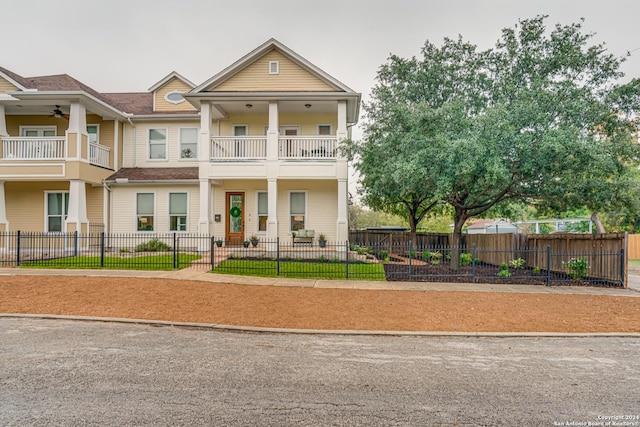 view of front of property with ceiling fan and a balcony