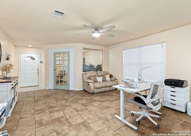 office space with ceiling fan and a textured ceiling