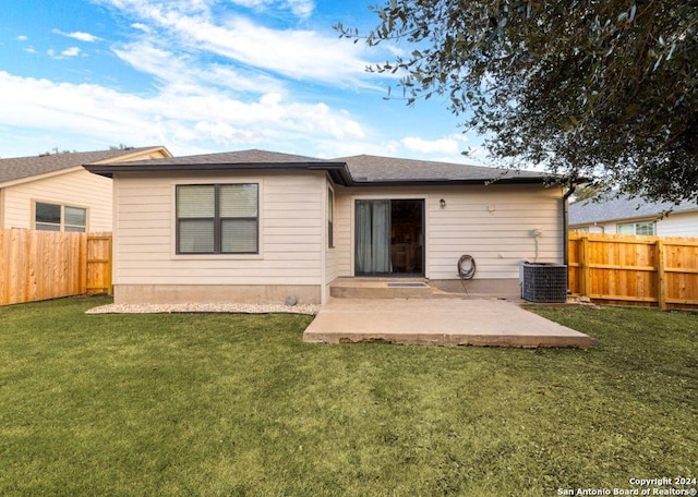 rear view of property with a yard, a patio, and central AC unit