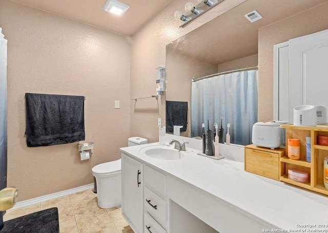 bathroom featuring tile patterned floors, vanity, and toilet