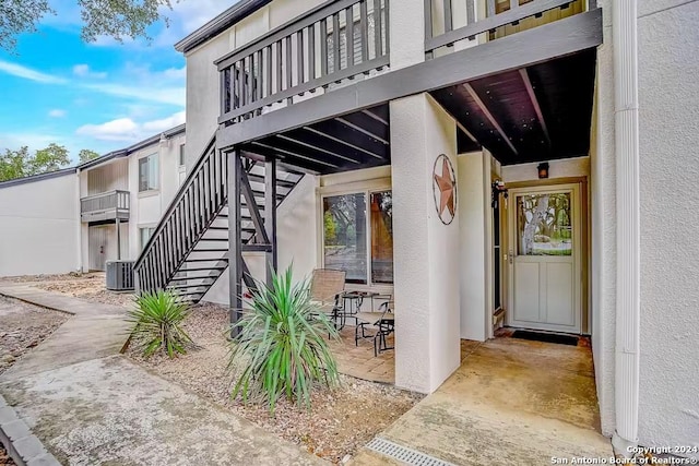 doorway to property with central AC unit