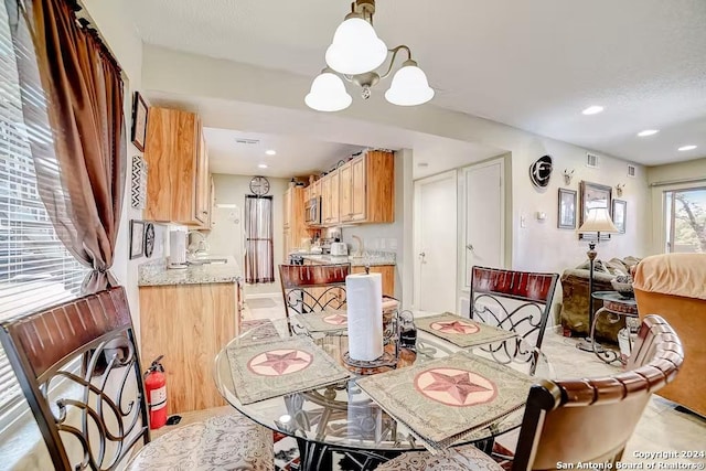 dining room with a notable chandelier and sink