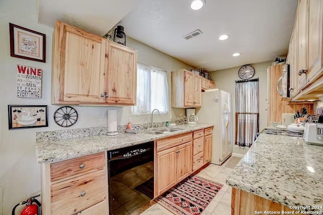 kitchen with light brown cabinetry, sink, light tile patterned flooring, and appliances with stainless steel finishes